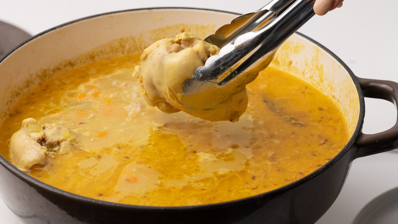 removing poached chicken from broth