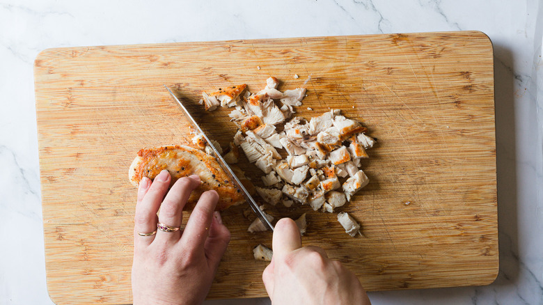 Chopping chicken into small pieces