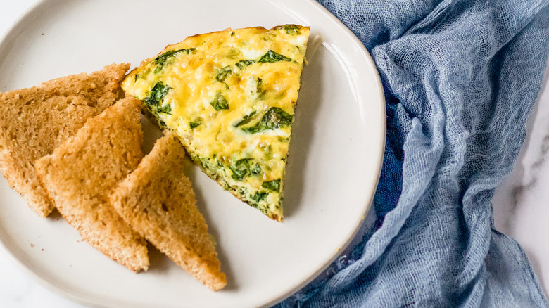 slices of quiche on plate with bread