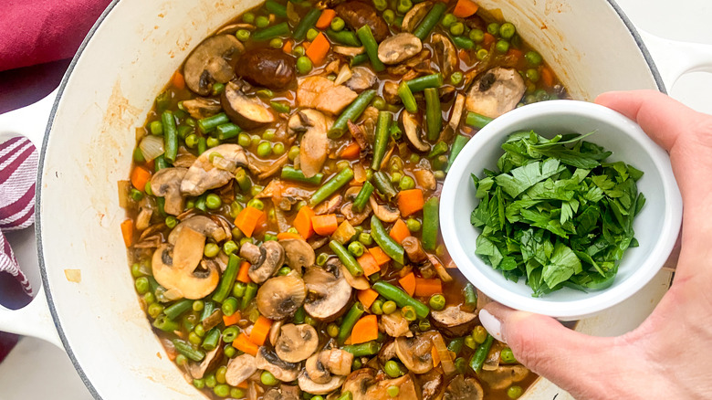 adding parsley to pot