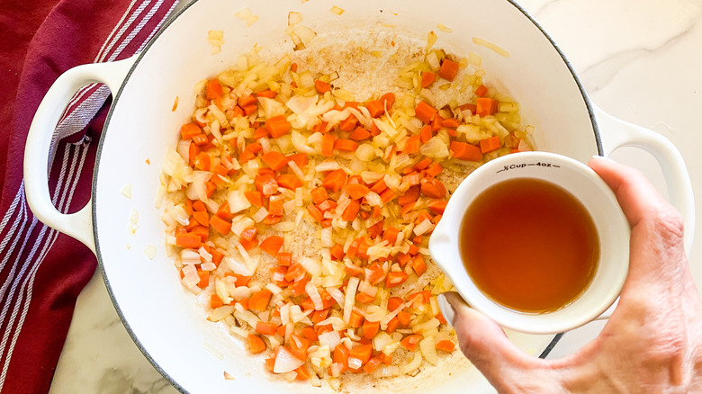 adding wine to pot