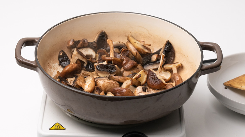 sauteing mushrooms in a pan