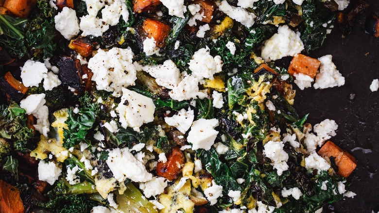 Extreme close up on feta, sweet potatoes and kale