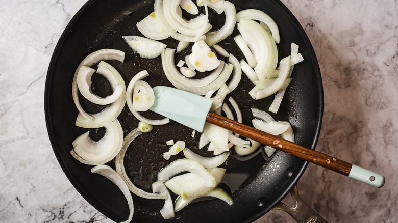 onion in pan with rubber spatula