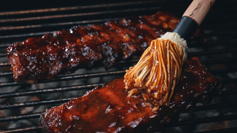 brushing ribs on grill 