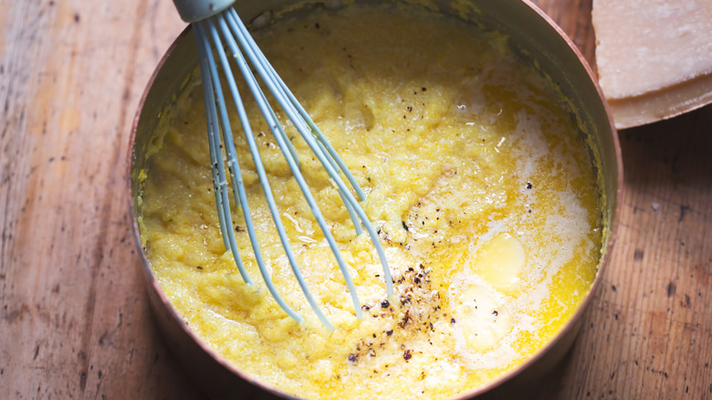 whisk in pot of grits