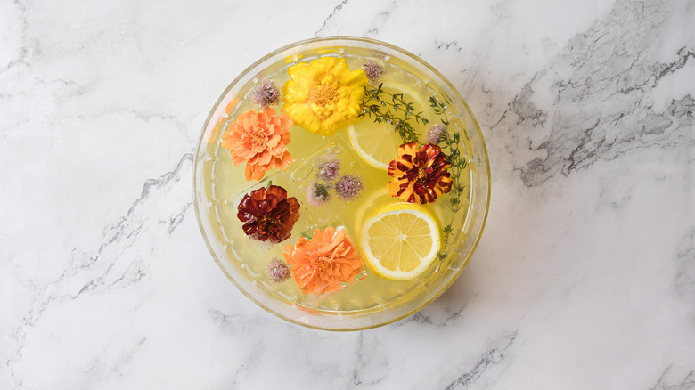 Large bowl of punch with flowers and herbs