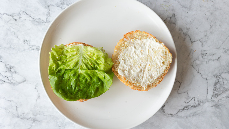 Two bun halves, one with lettuce 