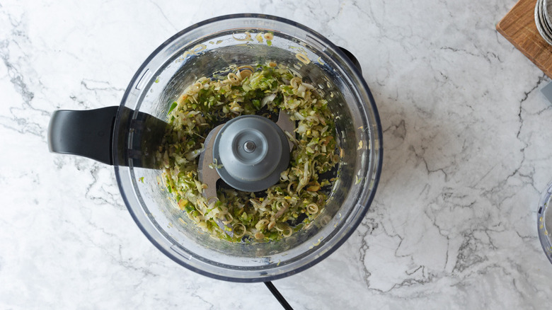 Processed herbs in food processor bowl