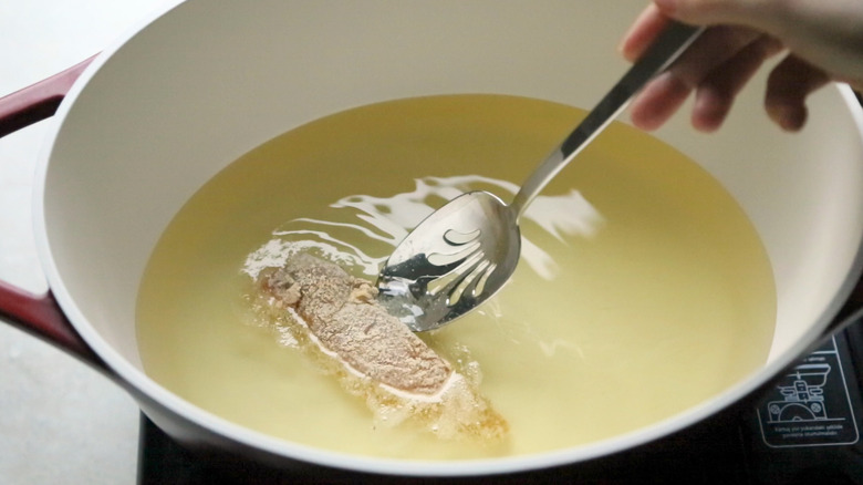 chicken tender frying in oil