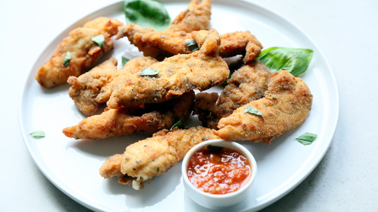 plate of chicken tenders with sauce