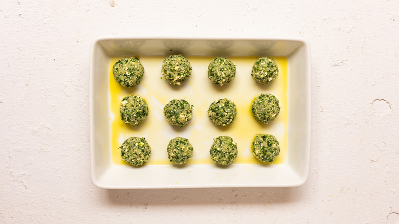 herby spinach quinoa balls in baking dish 