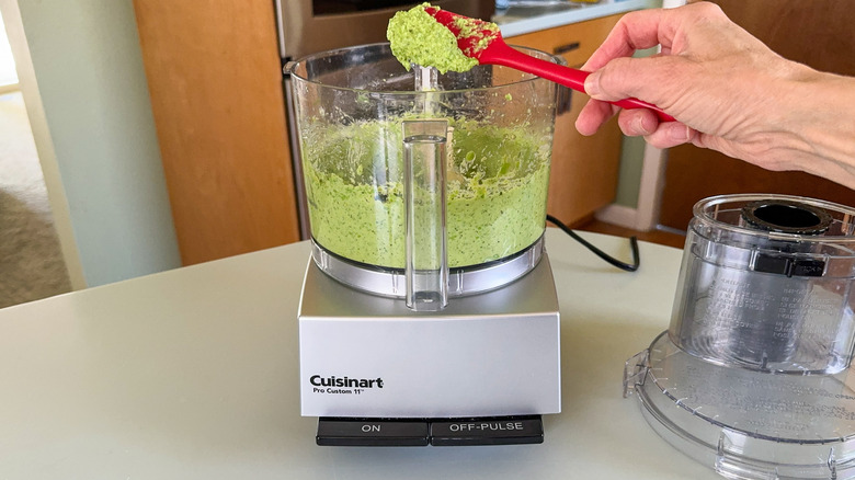 Processing herby spring pea dip in food processor