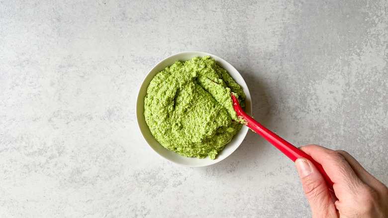 Herby spring pea dip in serving bowl