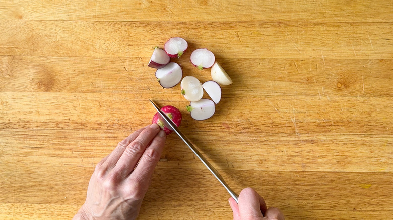 Cutting radishes on cutting board