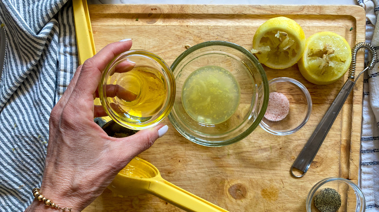 adding oil to lemon dressing