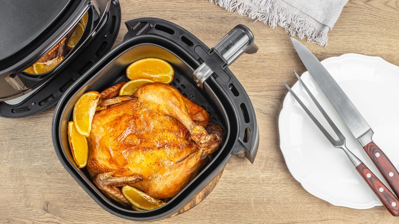 Whole bird in an air fryer with orange slices