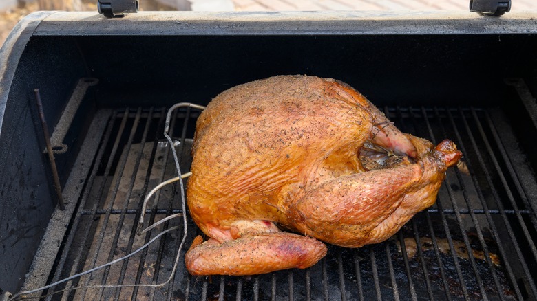 Cooked turkey on a smoker with meat thermometers