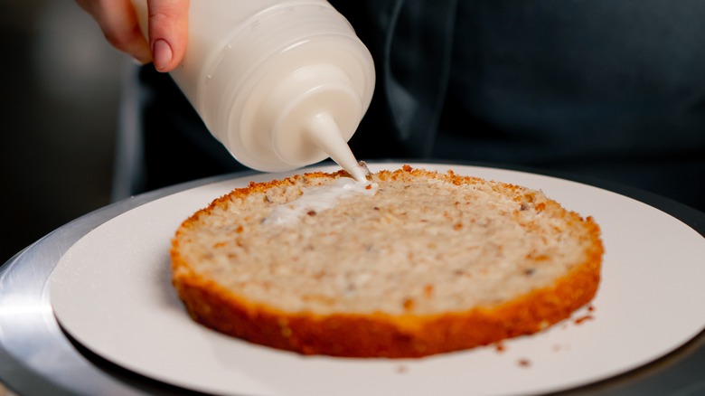 simple syrup in a squirt bottle over cake