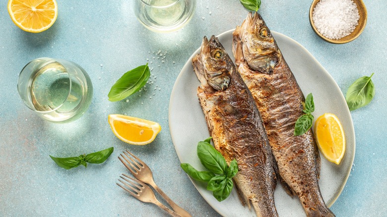 Overview of whole cooked fish with white wine