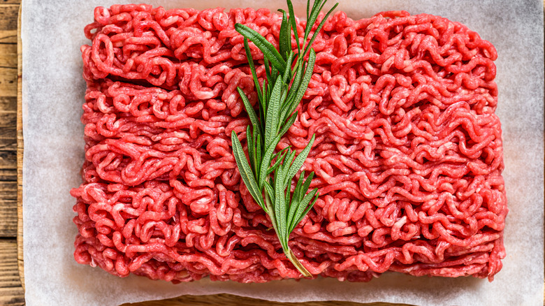 Raw ground beef with rosemary