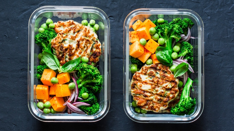 Two prepped chicken and veggies Tupperware