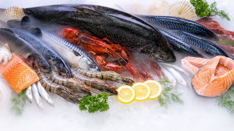 Assorted raw whole seafood on ice