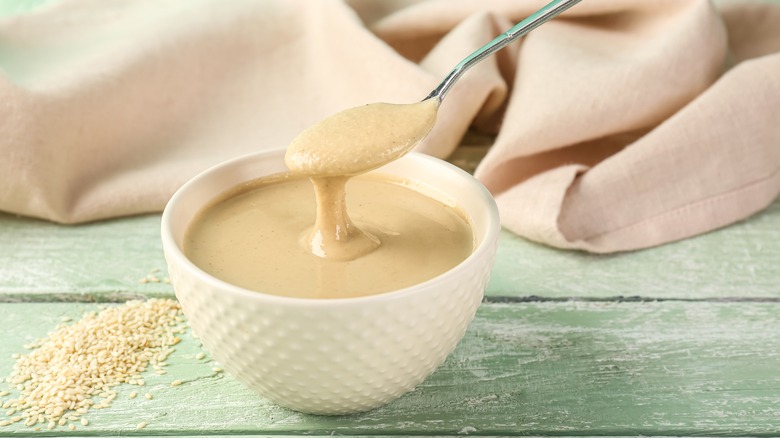 Spoon over bowl of tahini