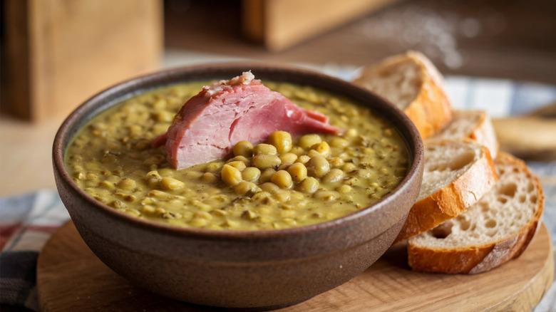 Split pea soup with a big chunk of ham and a side of fresh bread