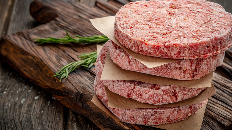 Stack of uncooked, frozen hamburgers