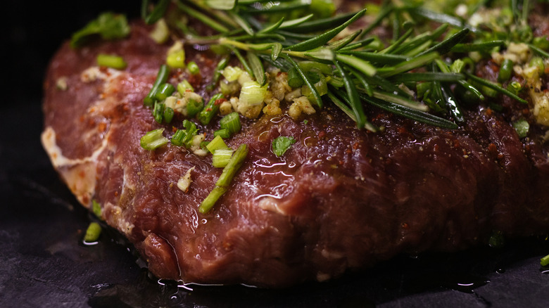 beef marinating with spices and herbs