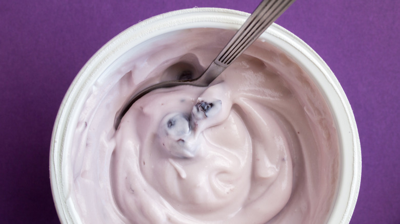 Hand removing yogurt from freezer