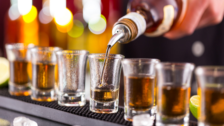 Bartender pouring a shot of well whiskey