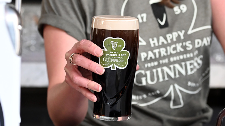 Bartender serving a Guinness pint