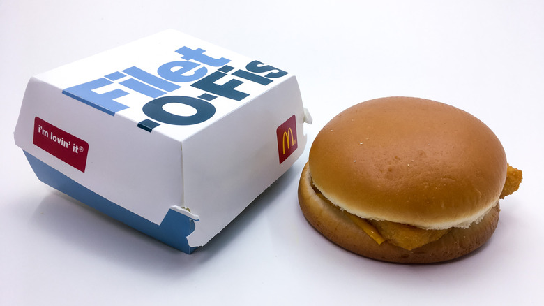 McDonald's filet-o-fish next to box on a white background