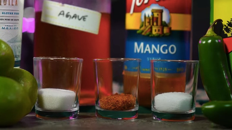 Three different dry cocktail rim ingredients in glasses