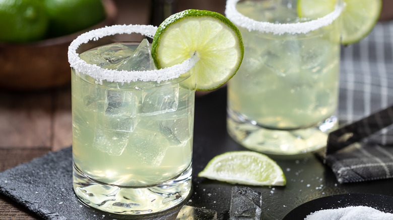 Two margarita cocktails with a salted rim