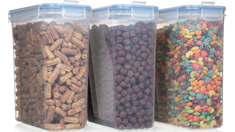 Three clear storage boxes filled with various cereals