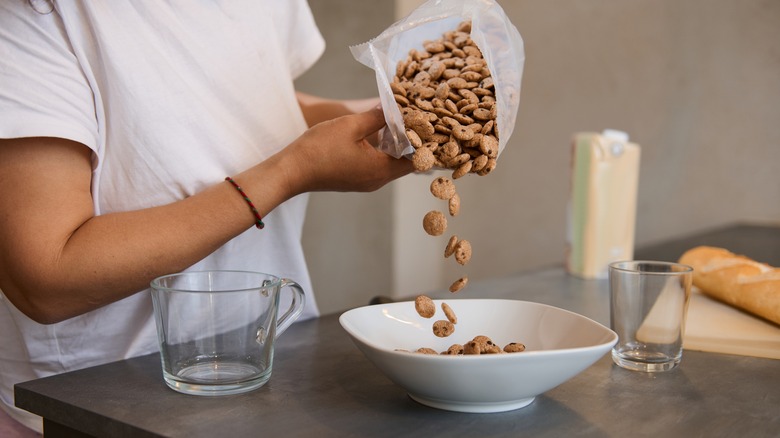 pouring cereal into a bowl