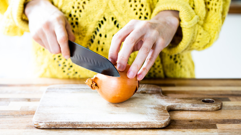 Slicing onion on cutting board