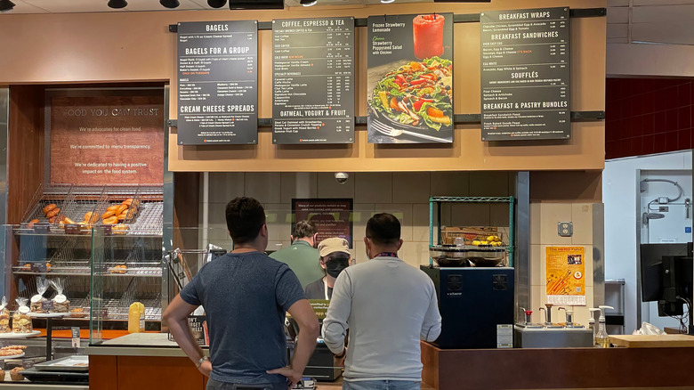 Breakfast time at a Panera Bread, with two customers ordering from the breakfast menu
