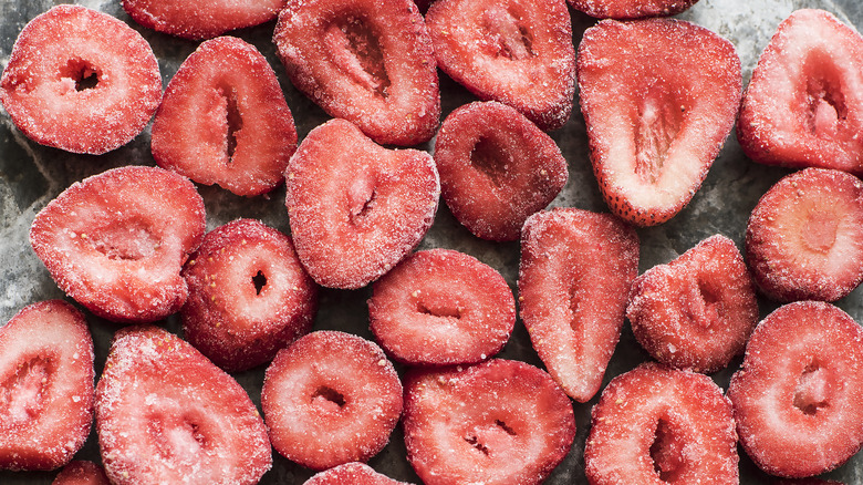 Frozen cut strawberries on a tray