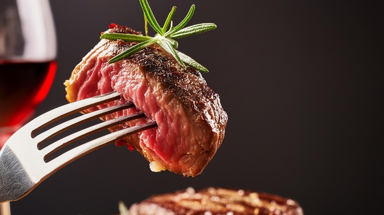 steak on fork in restaurant