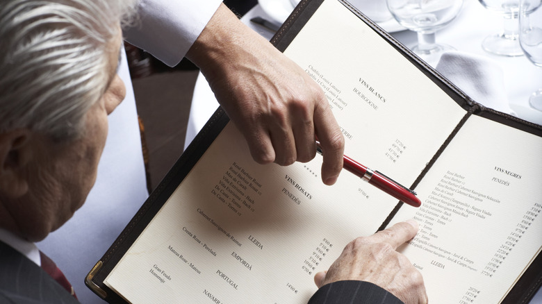 Man ordering from a restaurant menu