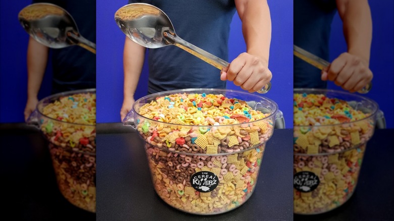 Hand holding a spoon over a giant bowl of cereal in the Cereal Killerz Kitchen challenge