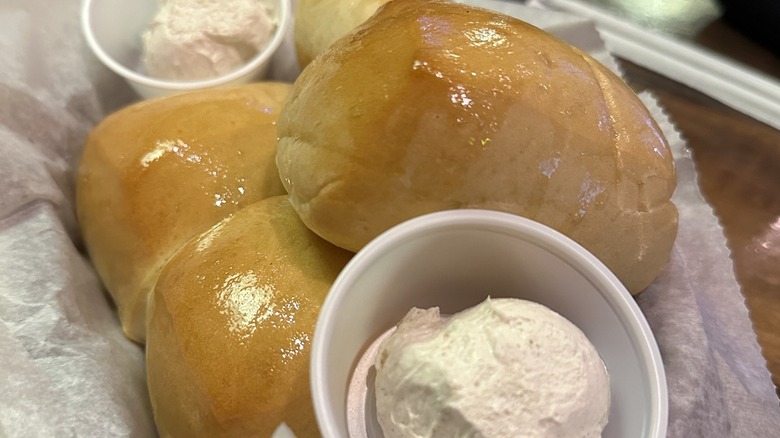 Dinner rolls in basket with butter