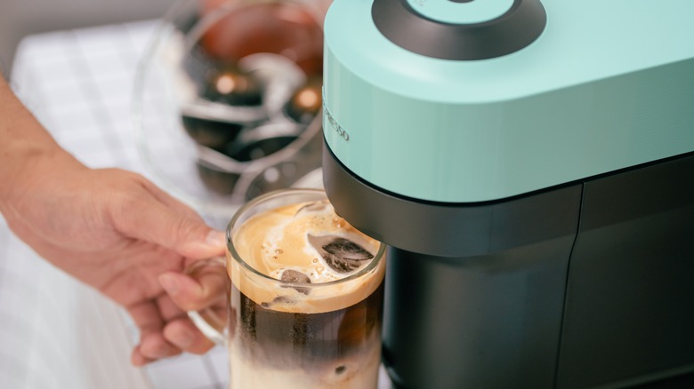 person using Nespresso Vertuo Pop machine