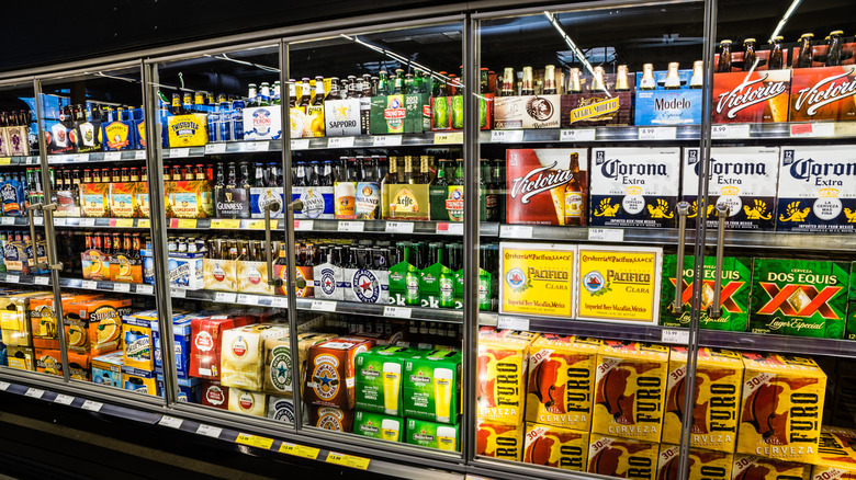 cases of beer in grocery store fridge