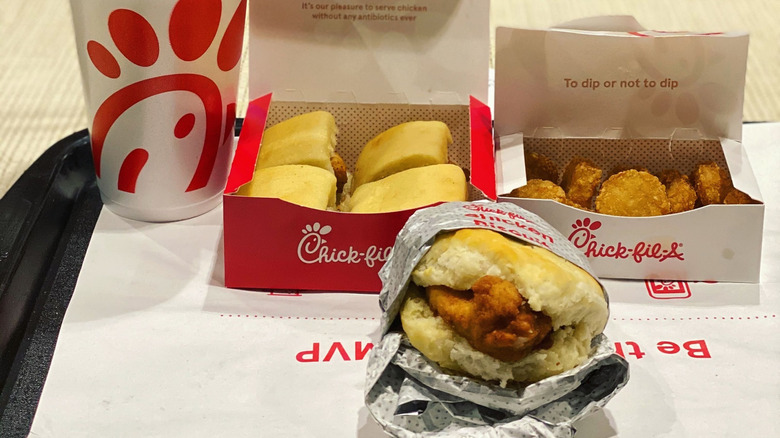 Tray of Chick-fil-A breakfast items, including chicken biscuit, chicken minis, and hash browns