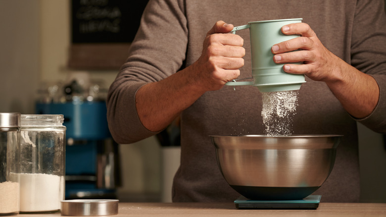 Person sifting flour